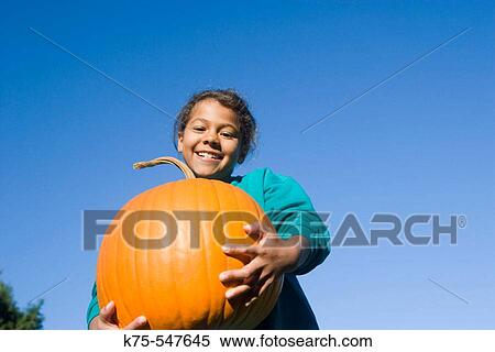 Young girl with big pumpkin View Large Photo Image Stock Photography - Young girl with big pumpkin. Fotosearch