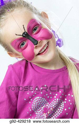 Stock Photo - Young girl with bodypaint, butterfly painted in face.. Fotosearch