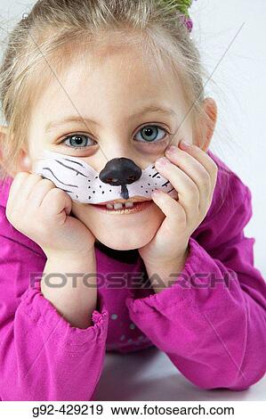Stock Photo - Young girl with bodypaint, cat nose painted in face.. Fotosearch
