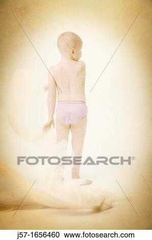 Stock Image - Young girl with cancer playing in studio with scarf. Fotosearch