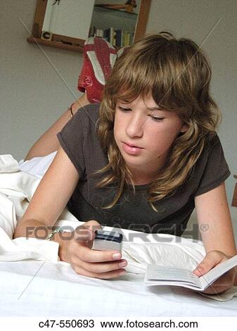 Young girl with cell phone View Large Photo Image Stock Image - Young girl with cell phone. Fotosearch