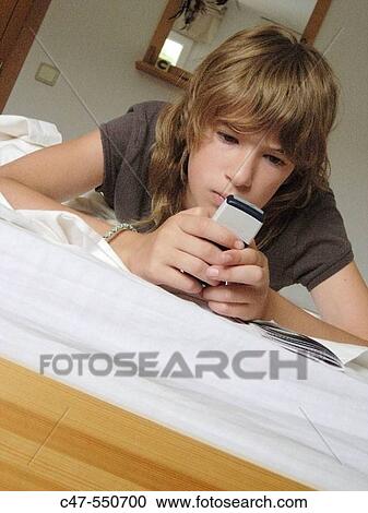 Young girl with cell phone View Large Photo Image Stock Image - Young girl with cell phone. Fotosearch