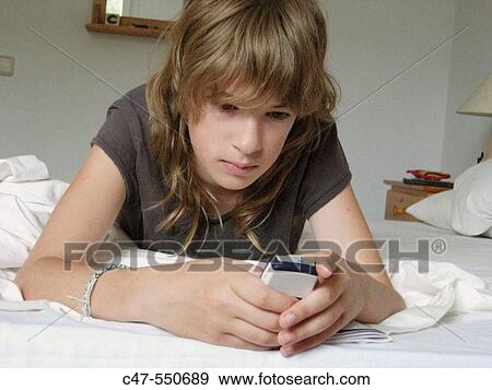 Young girl with cell phone View Large Photo Image Stock Photo - Young girl with cell phone. Fotosearch