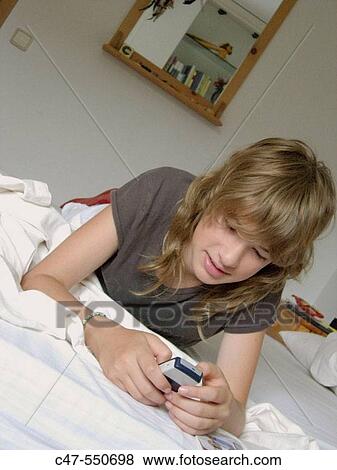 Stock Photo - Young girl with cell phone. Fotosearch