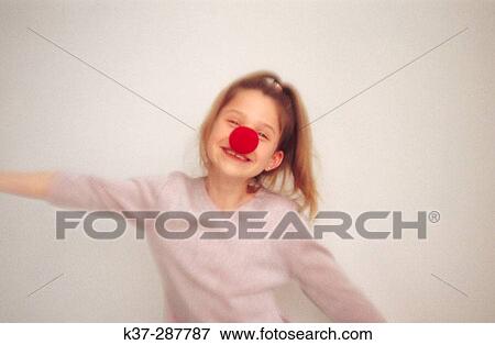 Young girl with clown nose dancing View Large Photo Image Stock Photo - Young girl with clown nose dancing. Fotosearch