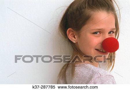 Stock Photography - Young girl with clown nose portrait. Fotosearch