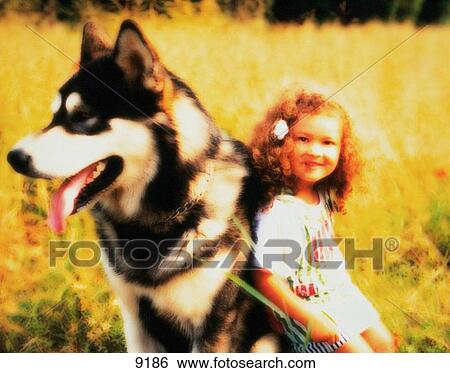 Stock Photograph - Young girl with dog. Fotosearch