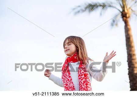 Young girl with eyes closed and arms opened at the sea View Large Photo Image Stock Photography - Young girl with eyes closed and arms opened at the sea. Fotosearch