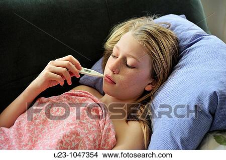 Picture - Young girl with fever. Fotosearch