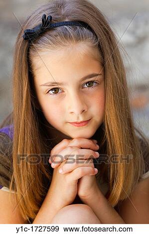 Stock Photo - Young girl with fingers crossed. Fotosearch