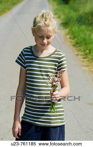 Young girl with flowers in her hand. View Large Photo Image Stock Photography - Young girl with flowers in her hand.. Fotosearch