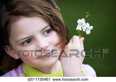 Stock Image - Young girl with flowers. Fotosearch