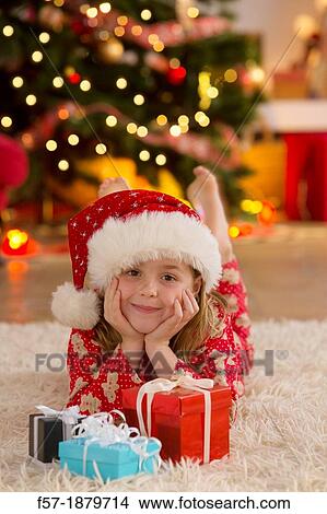 Young girl with gifts at Christmas time View Large Photo Image Picture - Young girl with gifts at Christmas time. Fotosearch