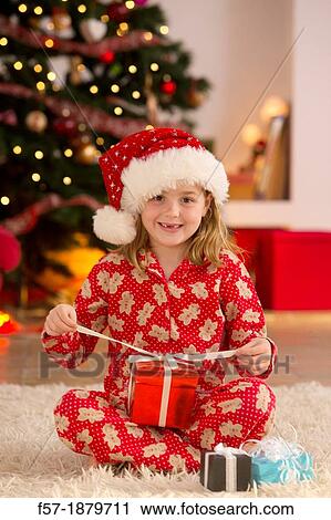 Young girl with gifts at Christmas time View Large Photo Image Stock Image - Young girl with gifts at Christmas time. Fotosearch