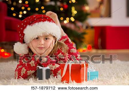 Young girl with gifts at Christmas time View Large Photo Image Stock Image - Young girl with gifts at Christmas time. Fotosearch