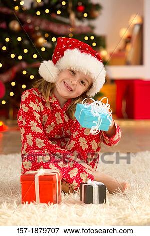 Young girl with gifts at Christmas time View Large Photo Image Stock Photo - Young girl with gifts at Christmas time. Fotosearch