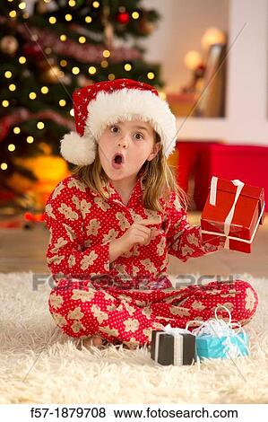 Young girl with gifts at Christmas time View Large Photo Image Stock Photo - Young girl with gifts at Christmas time. Fotosearch