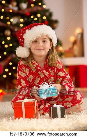 Young girl with gifts at Christmas time View Large Photo Image Stock Photograph - Young girl with gifts at Christmas time. Fotosearch