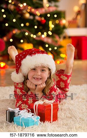 Young girl with gifts at Christmas time View Large Photo Image Stock Photograph - Young girl with gifts at Christmas time. Fotosearch