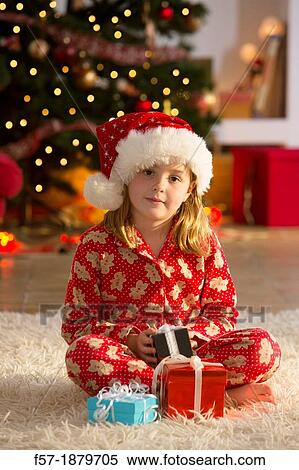 Young girl with gifts at Christmas time View Large Photo Image Stock Photography - Young girl with gifts at Christmas time. Fotosearch