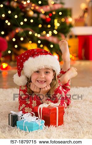 Young girl with gifts at Christmas time View Large Photo Image Stock Photography - Young girl with gifts at Christmas time. Fotosearch