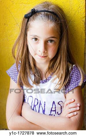 Stock Photo - Young girl with hands crossed. Fotosearch