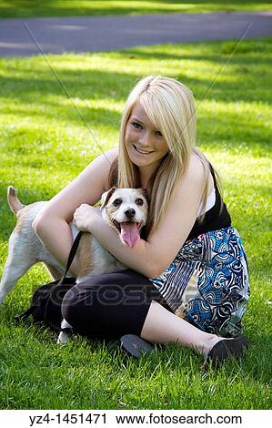 Young girl with her dog at the park View Large Photo Image Stock Image - Young girl with her dog at the park. Fotosearch
