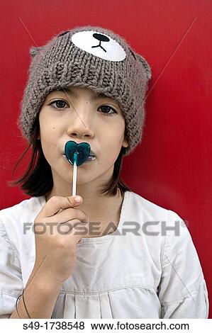 Stock Photo - Young girl with lollipop candy. Fotosearch