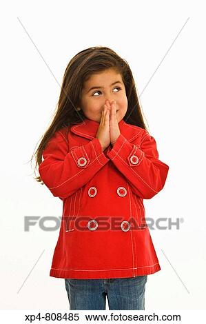 Young girl with long brown hair wearing a bright red jacket with large red and white buttons on the front. Her hands are clasped together below her nose, her eyes looking up to the right. View Large Photo Image Stock Photography - Young girl with long brown hair wearing a bright red jacket with large red and white buttons on the front. Her hands are clasped together below her nose, her eyes looking up to the right.. Fotosearch