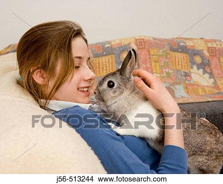 Young girl with pet rabbit View Large Photo Image Picture - Young girl with pet rabbit. Fotosearch