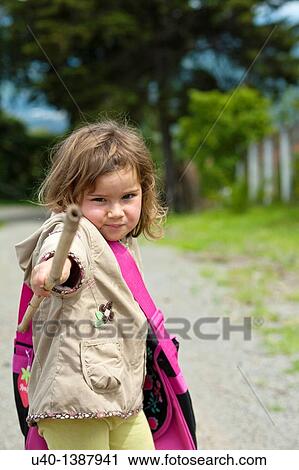 Stock Image - Young girl with stick. Fotosearch
