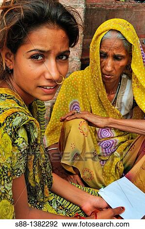 Stock Image - Young girlon the street by the Ganges river. Fotosearch
