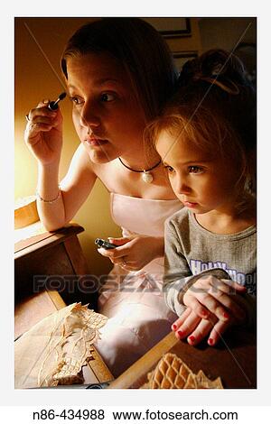Young girls applying makeup View Large Photo Image Stock Photo - Young girls applying makeup. Fotosearch