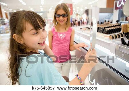 young girls at cosmetic counter View Large Photo Image Stock Photo - young girls at cosmetic counter. Fotosearch