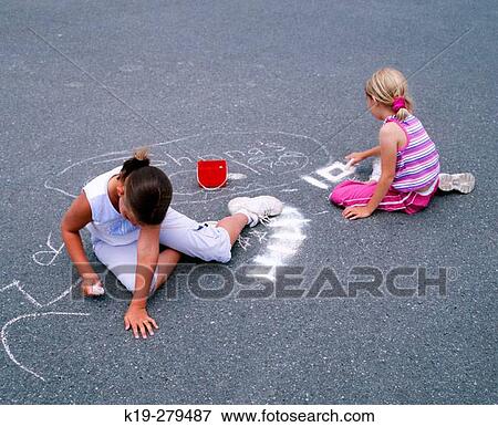 Young girls drawing on pavement with chalk. Anacortes, Skagit County. Washington, USA View Large Photo Image Stock Photo - Young girls drawing on pavement with chalk. Anacortes, Skagit County. Washington, USA. Fotosearch