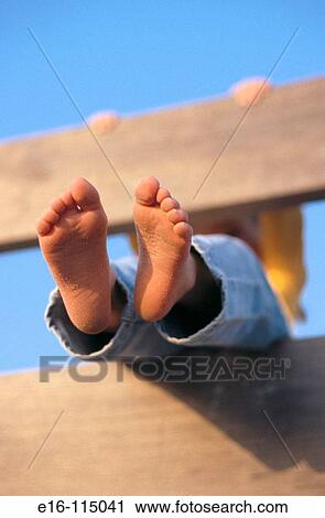 Young girl's feet through a fence View Large Photo Image Stock Image - Young girl's feet through a fence. Fotosearch