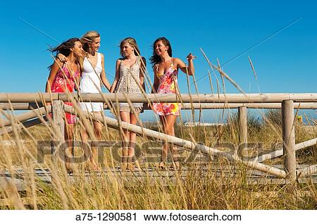 Young girls on the beach View Large Photo Image Stock Image - Young girls on the beach. Fotosearch