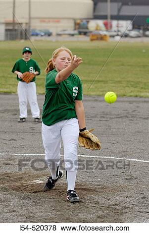 Stock Photo - Young girls play softball. Fotosearch
