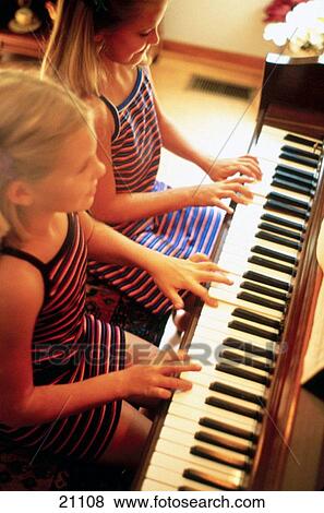 Young girls play the piano View Large Photo Image Stock Photo - Young girls play the piano. Fotosearch
