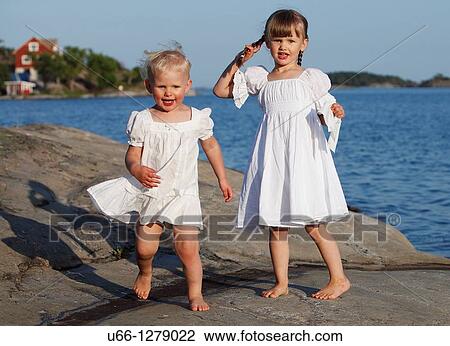 Stock Image - Young girls playing N? velso Sm? land Sweden.. Fotosearch