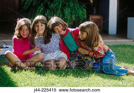 Young girls sitting on the grass smiling View Large Photo Image Stock Photography - Young girls sitting on the grass smiling. Fotosearch