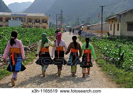 Stock Photo - young girls walking together, around Sa Phin, Dong Van plateau, Ha Giang province, northern Vietnam, southeast asia. Fotosearch