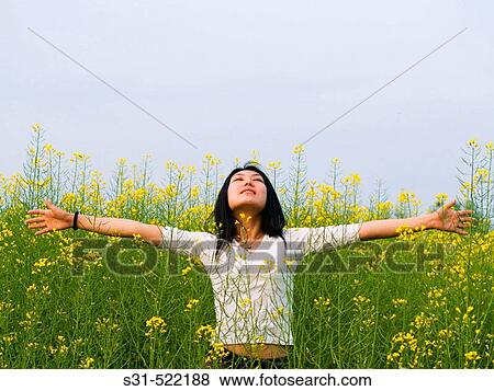 Young good looking asian (chinese) girl enjoying the outdoors in a rape field View Large Photo Image Stock Photo - Young good looking asian (chinese) girl enjoying the outdoors in a rape field. Fotosearch