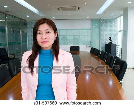 Young good looking asian executive in a meeting room View Large Photo Image Stock Photo - Young good looking asian executive in a meeting room. Fotosearch