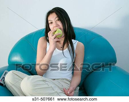 Young good looking asian girl posing with a green apple View Large Photo Image Stock Image - Young good looking asian girl posing with a green apple. Fotosearch