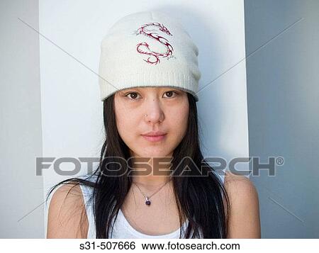 Young good looking asian girl wearing a winter hat View Large Photo Image Stock Photograph - Young good looking asian girl wearing a winter hat. Fotosearch