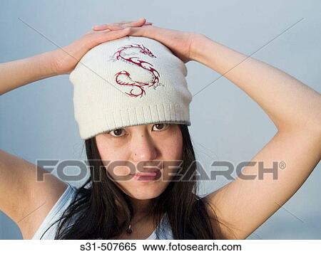 Young good looking asian girl wearing a winter hat View Large Photo Image Stock Photography - Young good looking asian girl wearing a winter hat. Fotosearch