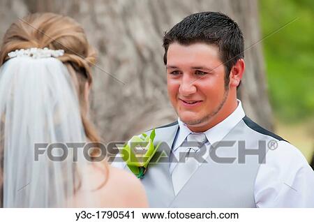 Young groom looking at the bride at an outdoor wedding in Texas, USA View Large Photo Image Stock Image - Young groom looking at the bride at an outdoor wedding in Texas, USA. Fotosearch