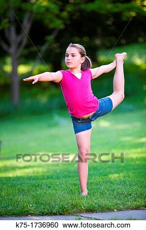 Stock Image - young gymnast practicing outdoors. Fotosearch