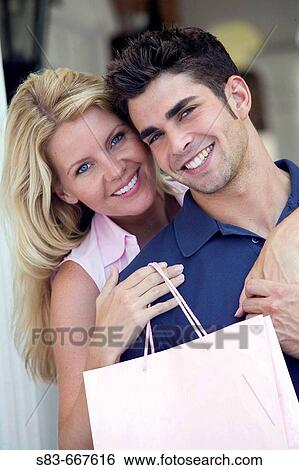 Young happy couple shopping View Large Photo Image Stock Photograph - Young happy couple shopping. Fotosearch